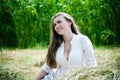 Young beautiful girl lying on hay one summer day