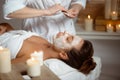 Young beautiful girl in mask for face relaxing in spa salon. Royalty Free Stock Photo