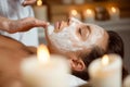 Young beautiful girl in mask for face relaxing in spa salon. Royalty Free Stock Photo