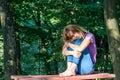 Young beautiful girl model in jeans and a T-shirt with long blond hair and sad smiles pensively posing for a walk in the autumn pa Royalty Free Stock Photo