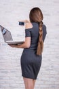 Female long-haired manager with notebook doing selfie by smartp Royalty Free Stock Photo