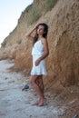 Young beautiful girl near the cliff and the sea Royalty Free Stock Photo