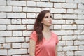 Young beautiful girl near white brick wall, street style, place Royalty Free Stock Photo