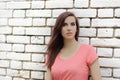 Young beautiful girl near white brick wall, street style, place Royalty Free Stock Photo