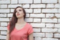 Young beautiful girl near white brick wall, street style, place Royalty Free Stock Photo