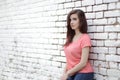 Young beautiful girl near white brick wall, street style, place Royalty Free Stock Photo