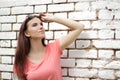 Young beautiful girl near white brick wall, street style, place Royalty Free Stock Photo