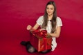 Young beautiful girl opens her christmas gift Royalty Free Stock Photo