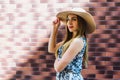 Young beautiful girl in overalls and a hat