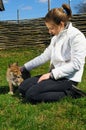 Young beautiful girl pets a puppy Royalty Free Stock Photo