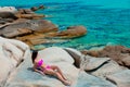 Young beautiful girl in pink bikini on a rock Royalty Free Stock Photo