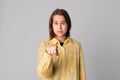 Young beautiful girl pointing with finger to the camera and to you, confident gesture looking serious Royalty Free Stock Photo