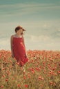 Young beautiful girl in poppy field Royalty Free Stock Photo