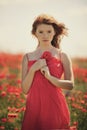 Young beautiful girl in poppy field Royalty Free Stock Photo