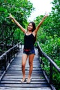 Young beautiful girl portrait on the wooden bridge in the mangrove forest Royalty Free Stock Photo