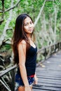 Young beautiful girl portrait on the wooden bridge in the mangrove forest Royalty Free Stock Photo