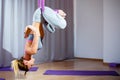 Young beautiful girl practicing aerial yoga in gym Royalty Free Stock Photo