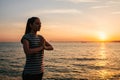 Young beautiful girl practicing yoga and meditation next to the sea at sunset. Sport. Yoga. Meditation. Recreation Royalty Free Stock Photo