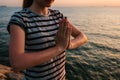 Young beautiful girl practicing yoga and meditation on the rocks next to the sea at sunset. Sport. Yoga. Meditation Royalty Free Stock Photo