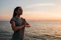 Young beautiful girl practicing yoga and meditation on the rocks next to the sea at sunset. Sport. Yoga. Meditation Royalty Free Stock Photo