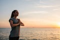 Young beautiful girl practicing yoga and meditation on the rocks next to the sea at sunset. Sport. Yoga. Meditation Royalty Free Stock Photo