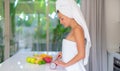 Young beautiful girl preparing fruit salad in the morning at the kitchen Royalty Free Stock Photo