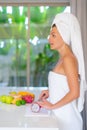 Young beautiful girl preparing fruit salad in the morning at the kitchen Royalty Free Stock Photo