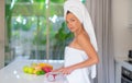 Young beautiful girl preparing fruit salad in the morning at the kitchen Royalty Free Stock Photo