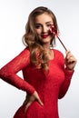 Young beautiful girl in a red dress smiles and looks at the camera. Studio shot Royalty Free Stock Photo