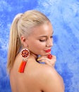 Young beautiful girl in red earrings on an abstract background Royalty Free Stock Photo