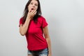 A young, beautiful girl is sexually wiping her lips with her hands. Isolated on a light background. Different human emotions, Royalty Free Stock Photo