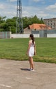 Young beautiful girl in short white dress with windswept hair