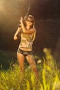 Young beautiful girl with a shotgun in an outdoor Royalty Free Stock Photo