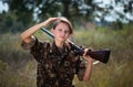 Young beautiful girl with a shotgun in an outdoor Royalty Free Stock Photo