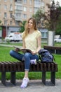 Young beautiful girl sitting on a bench in the summer park Royalty Free Stock Photo