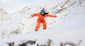 Young beautiful girl snowboarder in motion