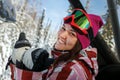 Young beautiful girl snowboarder smiling and showing thumbs up.