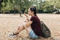 Young beautiful girl speaks a voice command into a cell phone. Royalty Free Stock Photo