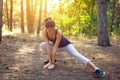 Young beautiful girl sports in the autumn forest at sunset Royalty Free Stock Photo