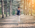 Young beautiful girl sports in the autumn forest at sunset Royalty Free Stock Photo