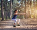 Young beautiful girl sports in the autumn forest at sunset Royalty Free Stock Photo