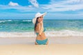 Young beautiful girl in a straw white hat back to the viewer on Royalty Free Stock Photo