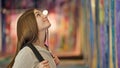 Young beautiful girl student wearing backpack looking around smiling at art gallery Royalty Free Stock Photo