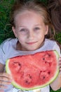 Young beautiful girl summer portrait. smiling childr outdoor. teen with watermelon. happy smiling girl eating watermelon in park