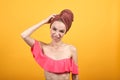 Young girl with towel on her head over isolated orange background shows emotions Royalty Free Stock Photo