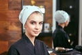 Young, beautiful girl with a towel on his head after shampooing