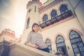 Young beautiful girl traveler posing near palace castle building in Kosava Kossovo in sunny summer day