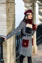 Young beautiful girl with very long hair looking away wearing winter coat and cap outdoors. Royalty Free Stock Photo