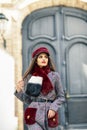 Young beautiful girl with very long hair looking away wearing winter coat and cap outdoors. Royalty Free Stock Photo