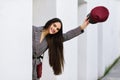 Young beautiful girl with very long hair wearing winter coat and cap outdoors Royalty Free Stock Photo